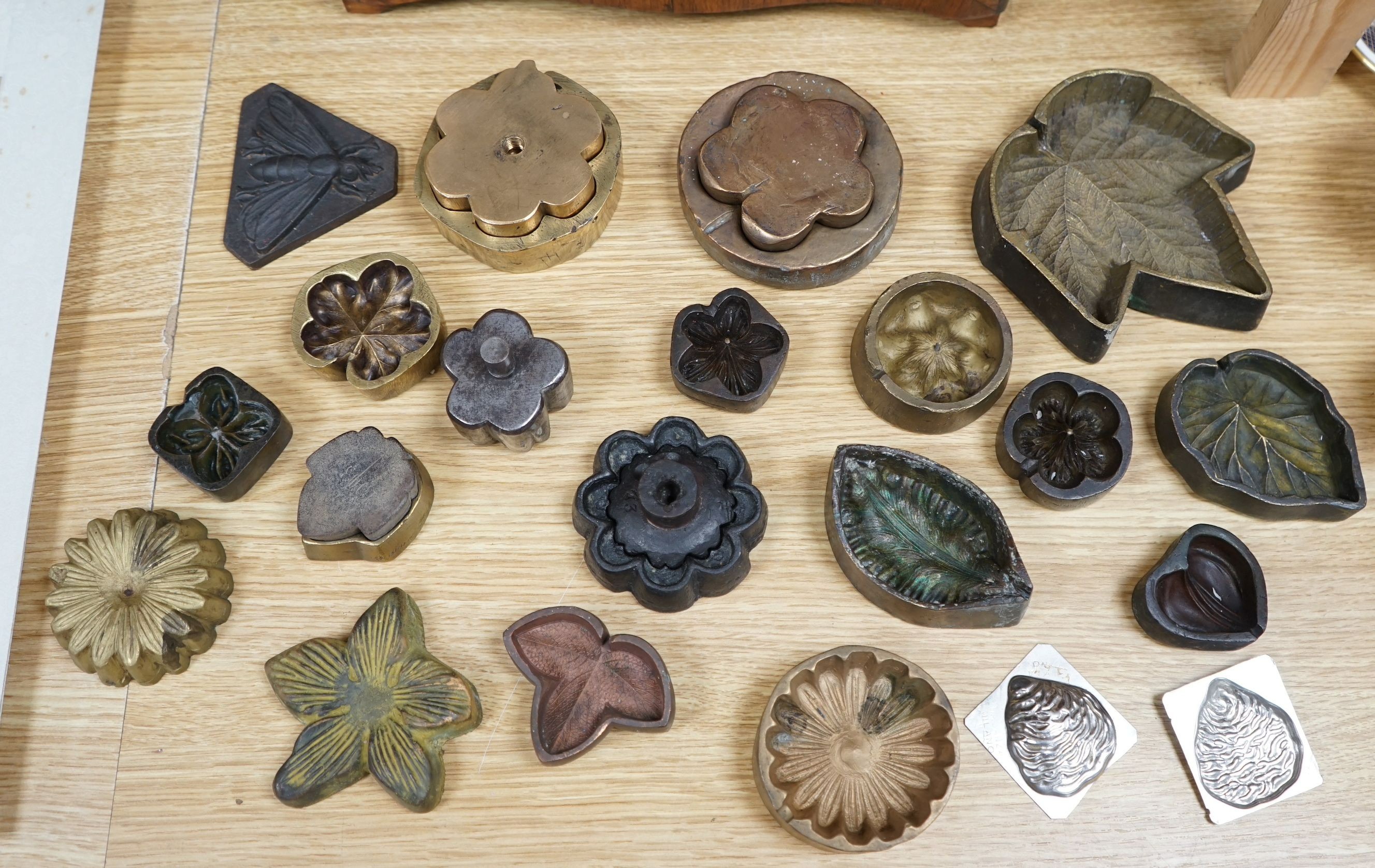 A collection of metal pattern moulds possibly for embossing silk (19) and two other moulds